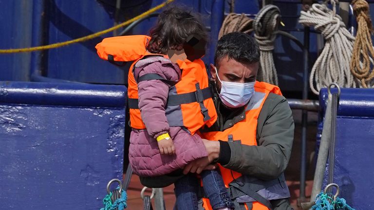 Young children amongst a group of people thought to be migrants are brought in to Dover, Kent