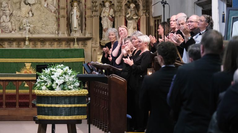 The congragation holds a round of applause during funeral of  Barnaby Webber 