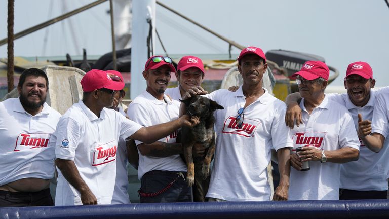 The crew of the Mexican tuna boat 'Maria Delia' pose for pictures with Bella.  Photo: AP