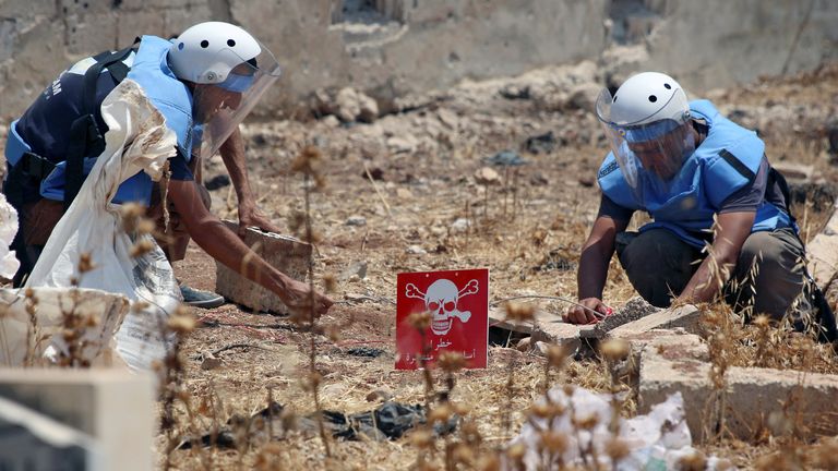People clearing cluster munitions in Syria in 2017