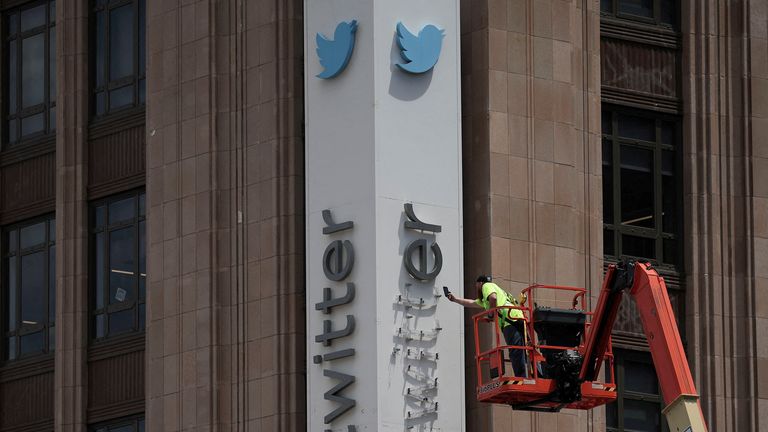 A worker dismantles a Twitter's sign at Twitter's corporate headquarters building as Elon Musk renamed Twitter as X and unveiled a new logo, in downtown San Francisco, California, U.S., July 24, 2023. REUTERS/Carlos Barria  