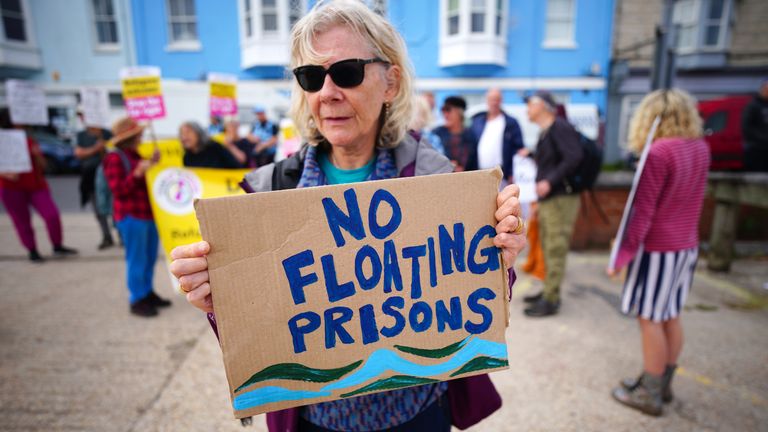 A protester in Portland in Dorset after the Bibby Stockholm accommodation barge arrived from dry dock in Falmouth, Cornwall, where it is due to house migrants. Picture date: Tuesday July 18, 2023. PA Photo. See PA story POLITICS Migrants. Photo credit should read: Ben Birchall/PA Wire 