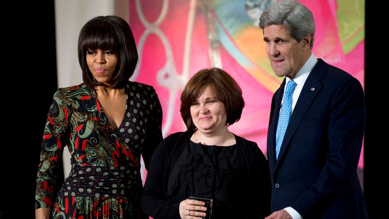 FILE - Then First lady Michelle Obama, left, and then Secretary of State John Kerry, right, honor Russian human rights activist, journalist Elena Milashina, with a Secretary of State&#39;s International Women of Courage Award during a ceremony at the State Department in Washington, Friday, March 8, 2013. Unidentified masked assailants in the Russian province of Chechnya have attacked and beaten a journalist and a lawyer. Novaya Gazeta journalist Elena Milashina and lawyer Alexander Nemov had just ar