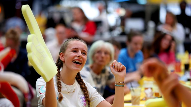 An England fan celebrates victory after watching a screening of the game at Wembley