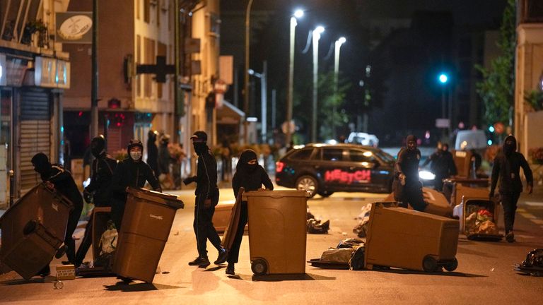 Demonstrators block a street with wheelie bins outside Paris. Pic: AP
