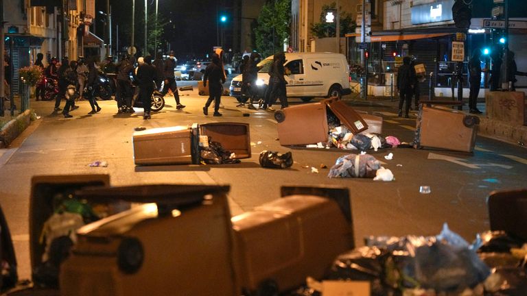 Protesters block a street with garbage cans in Colombes, outside Paris, France, Saturday, July 1, 2023. French President Emmanuel Macron urged parents Friday to keep teenagers at home and proposed restrictions on social media to quell rioting spreading across France over the fatal police shooting of a 17-year-old driver. (AP Photo/Lewis Joly)
