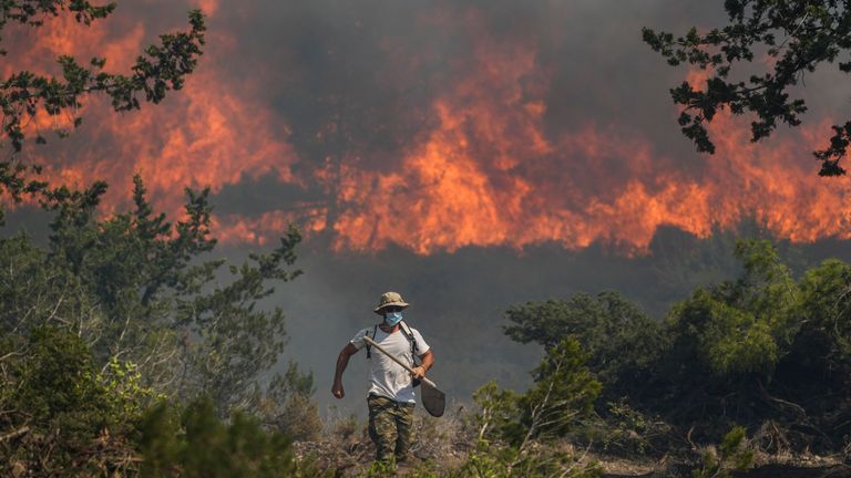 Flames burn a forest in Vati village on Rhodes Pic: AP