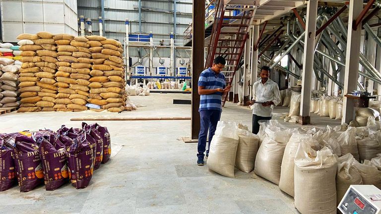 Harsh Singla, Rice Mill owner (rt) and an exporter look over the rice in Haryana  