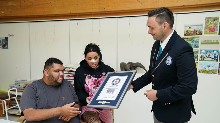 Guinness World Record Adjudicator Will Munford presents Harvey Price, sat by his mother Katie, with the Guinness World Record for the longest drawing of a train. Picture date: Thursday July 13, 2023.