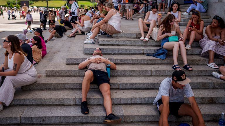 People rest during another hot day in Madrid, Spain. Pic: AP