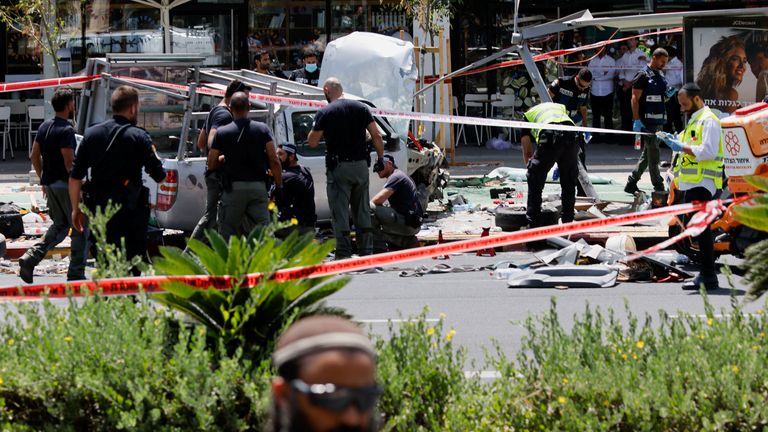 Israeli security personnel work at the scene of a ramming attack in Tel Aviv, Israel 