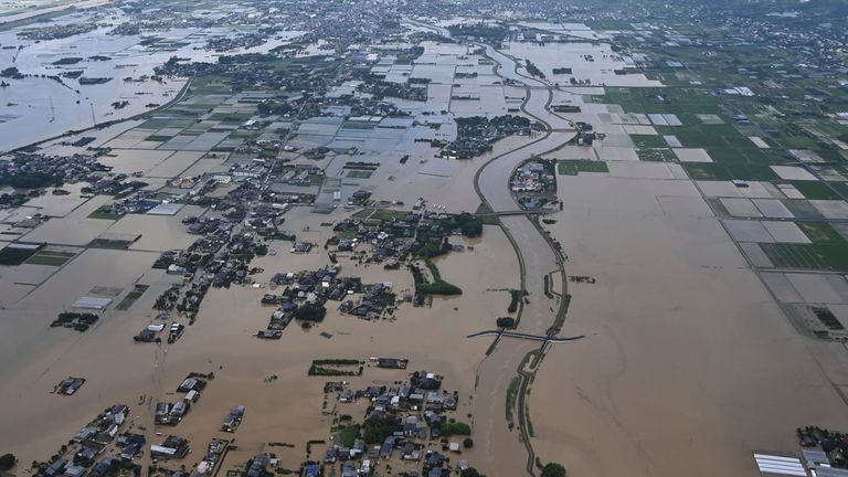 Houses and rice field flooded in Kurume, Fukuoka prefecture. Pic: The Yomiuri Shimbun/AP