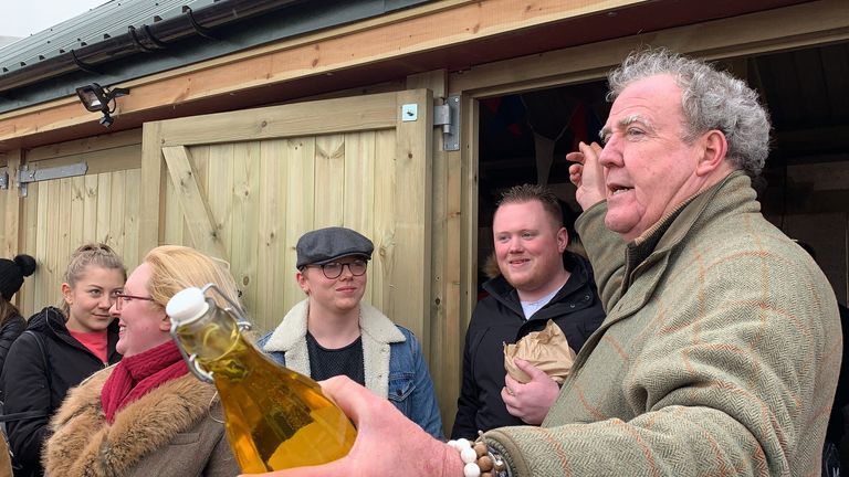 Undated handout photo issued by Blackball Media showing Jeremy Clarkson raffling water outside The Squat Shop, on his farm, Diddly Squat, near Chipping Norton in the Cotswolds which he is running as part of an Amazon Prime show called I Bought A Farm. Pic: Blackball Media