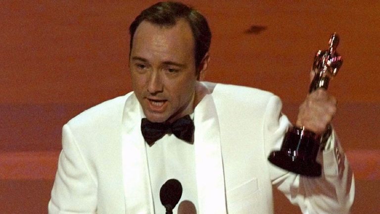 Actor Kevin Spacey holds up his Oscar after winning Best Supporting Actor for his roll in "The Usual Suspects" at the 68th Acad emy Awards March 25 1996. OSCARS
