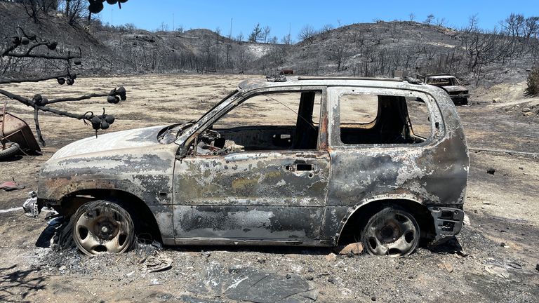 The burnt remains of a car destroyed by wildfires which have torn through Kiotari, Rhodes, Greece.