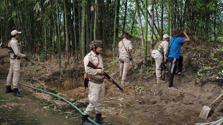 Meitei police watch positions of tribal Kuki bunkers in Kwakta, Manipur. Pic: AP