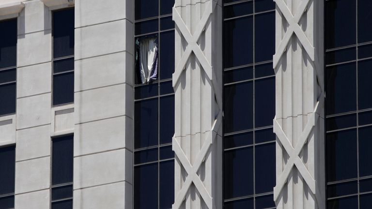 A curtain hangs out of a broken window on a hotel tower at Caesars Palace Hotel & Casino, Tuesday, July 11, 2023, in Las Vegas. (AP Photo/John Locher)