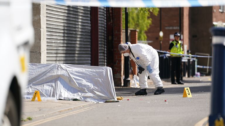 A forensic officer near the scene of the killing