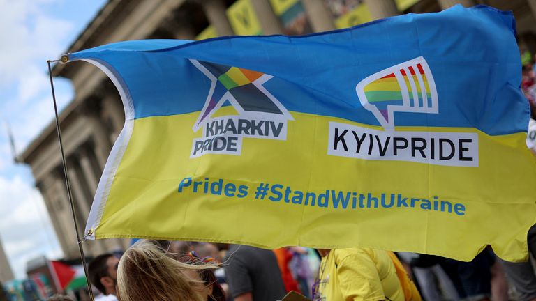 People hold a Ukraine flag as they take part in the Pride march in Liverpool, Britain, July 29, 2023. REUTERS/Phil Noble