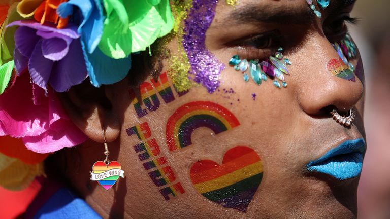 Nazir Udin displays his rainbow heart earrings before taking part in the Pride march in Liverpool, Britain, July 29, 2023. REUTERS/Phil Noble
