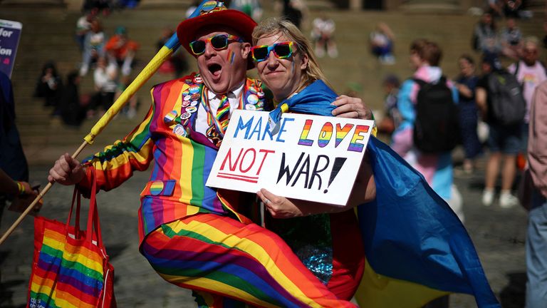 People hold an anti-war banner before taking part in the Pride march in Liverpool, Britain, July 29, 2023. REUTERS/Phil Noble
