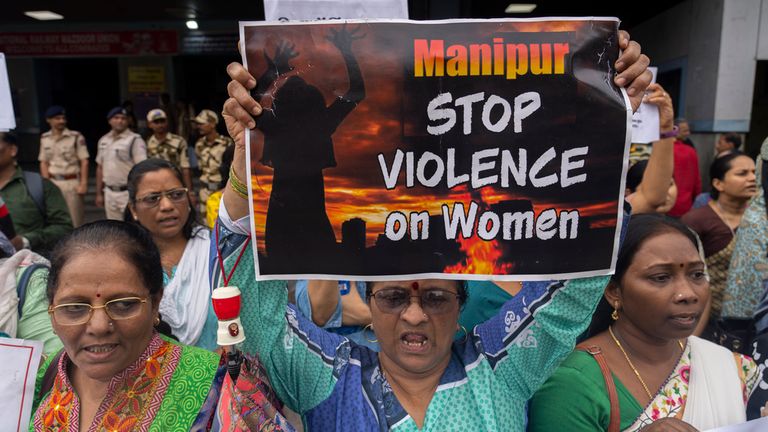 Activists protesting ethnic violence in northeastern Manipur state hold placards in Mumbai, India, Monday, July 24, 2023. Protests have erupted across the country after a video showing mob assaults on two women who were paraded naked sparked widespread outrage on social media. More than 130 people have been killed in the northeastern state since violence between two dominant ethnic groups erupted in early May. (AP Photo/Rafiq Maqbool)