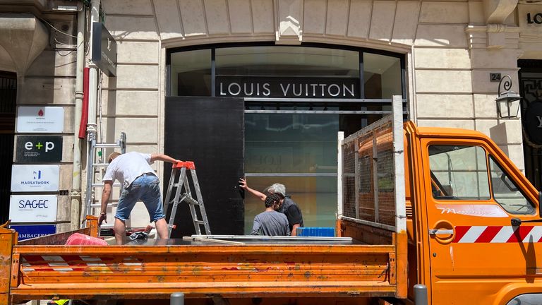 A Louis Vuitton store in Marseille is boarded up amid rioting in France