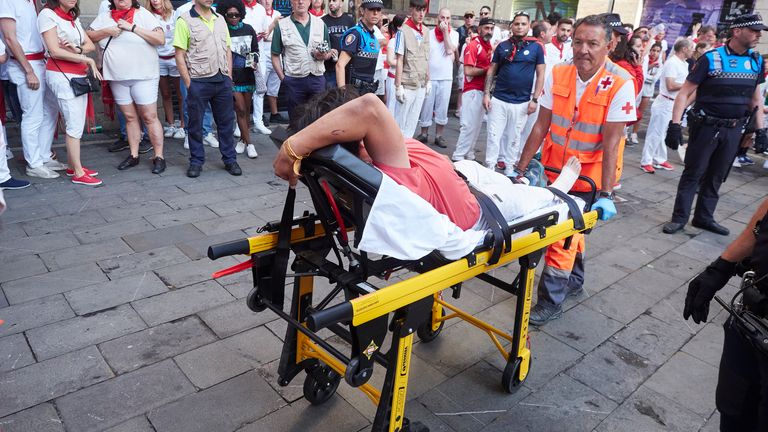 A medic carries an injured man on a stretcher during the fourth running of the bulls of the San Fermin 2023 fiestas in Pamplona