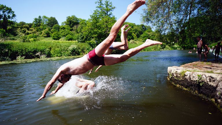People diving into the water at Warleigh Weir near Bath. The Met Office has issued guidance that most of the UK will meet heatwave criteria this week, and an amber alert for hot weather has been issued by the UK Health Security Agency (UKHSA). Picture date: Wednesday June 14, 2023. PA Photo. Photo credit should read: Ben Birchall/PA Wire