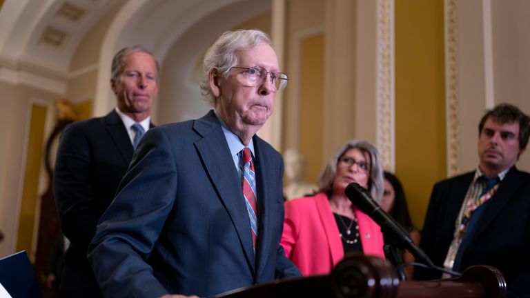 Senate Minority Leader Mitch McConnell, R-Ky., joined at left by Sen. John Thune, R-S.D., and Sen. Joni Ernst, R-Iowa, seems to freeze at the microphones as he arrived for a news conference at the Capitol in Washington, Wednesday, July 26, 2023. McConnell went to his office for a few minutes and returned to speak with reporters. (AP Photo/J. Scott Applewhite)