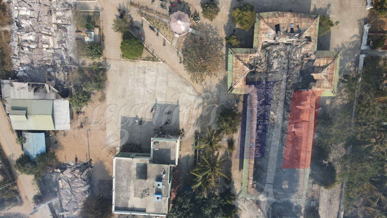 This picture shows the fire damage to a church, on the right of the image, in the village of Chan Thar.