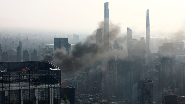 Smoke is visible after a construction crane caught fire on a high-rise building in Manhattan, New York City, U.S., July 26, 2023. REUTERS/Amr Alfiky
