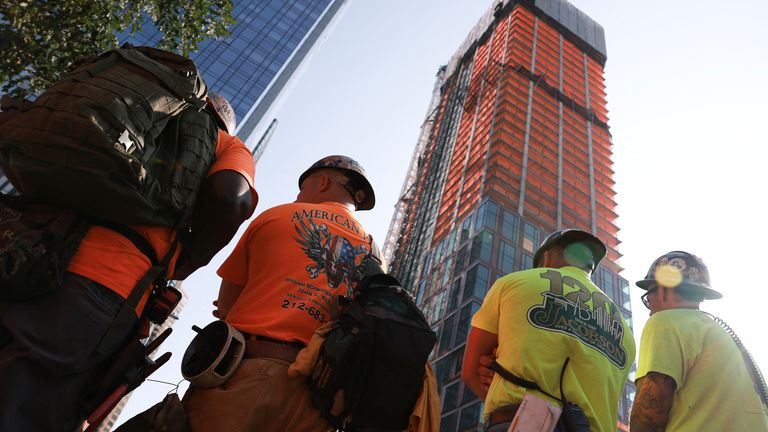 People gather after a construction crane caught fire on a high-rise building in Manhattan, New York City, U.S., July 26, 2023. REUTERS/Amr Alfiky
