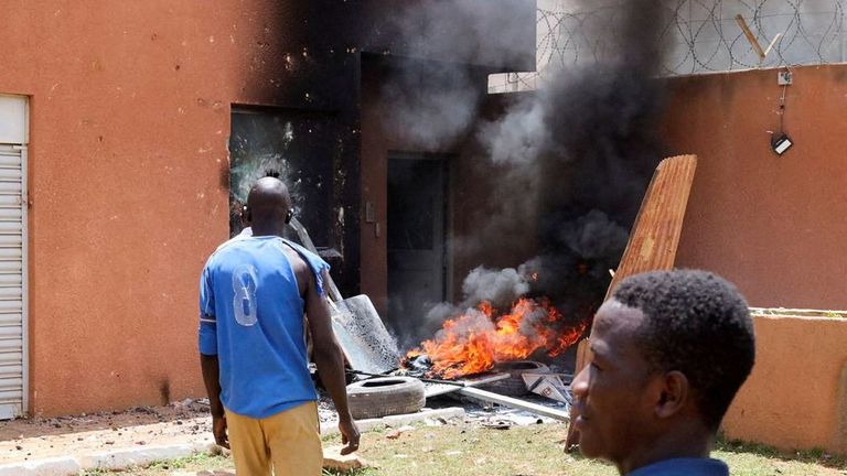 Pro-junta demonstrators gathered outside the French embassy, try to set it on fire before being dispersed by Nigerien security forces in Niamey, the capital city of Niger July 30, 2023. REUTERS/Souleymane Ag Anara REFILE – CORRECTING NATIONALITY NO RESALES. NO ARCHIVES
