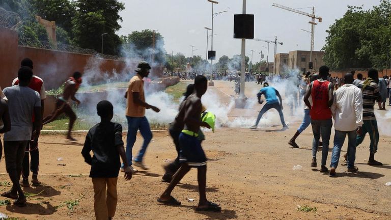 Nigerien security forces launch tear gas to disperse pro-junta demonstrators gathered outside the French embassy, in Niamey, the capital city of Niger July 30, 2023. REUTERS/Souleymane Ag Anara NO RESALES. NO ARCHIVES