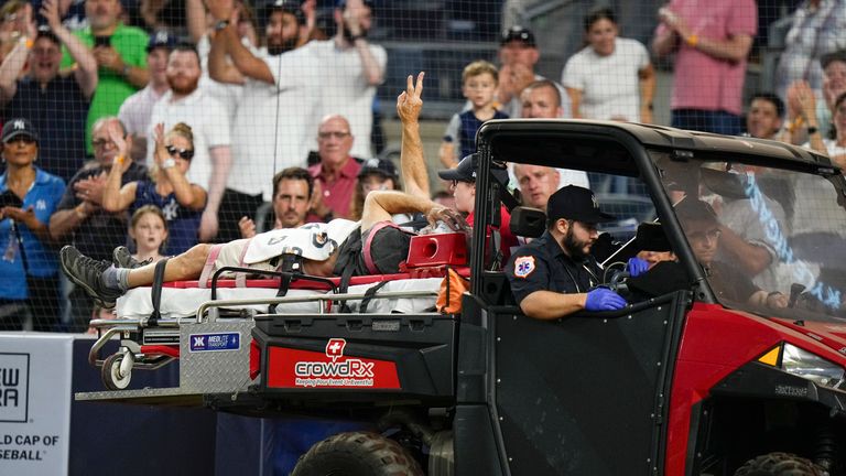 The cameraman waves to the crowd. Pic: AP