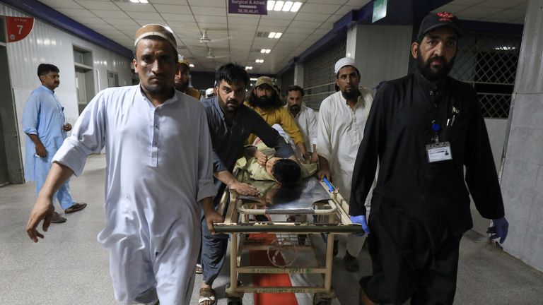 People transport a man, who was injured after a blast in Bajaur district of Khyber Pakhtunkhwa, at the Lady Reading Hospital in Peshawar, Pakistan July 30, 2023. REUTERS/Fayaz Aziz