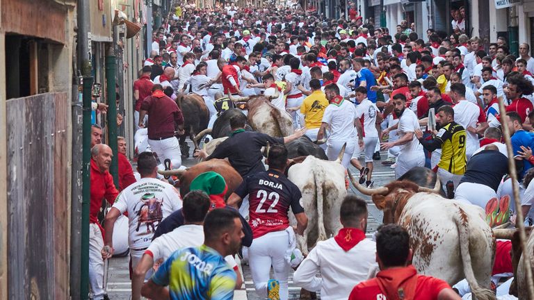 Runners during the fourth running of the bulls of the San Fermin in Pamplona 
Pic:Europa Press/AP