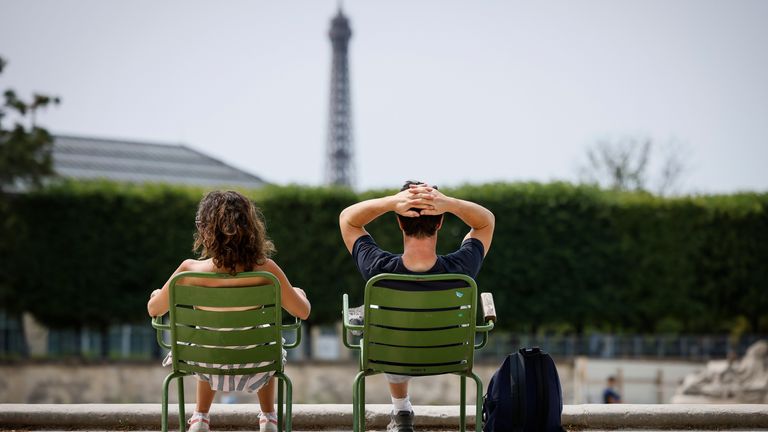 People enjoy the sun in the Tuileries gardens, Monday, July 10, 2023 in Paris where temperatures are expected to rise up to 30 degrees Celsius (86 degrees Fahrenheit). (AP Photo/Thomas Padilla)