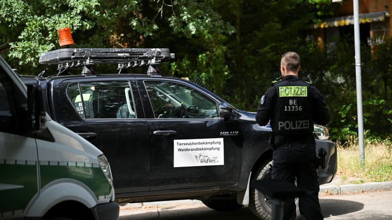 A police officer stands next to a vehicle of &#39;Animal Disease Control. Forest Fire Control&#39;, after police warned the public that a suspected lioness was on the loose, in Zehlendorf, Berlin, Germany July 20, 2023. REUTERS/Annegret Hilse
