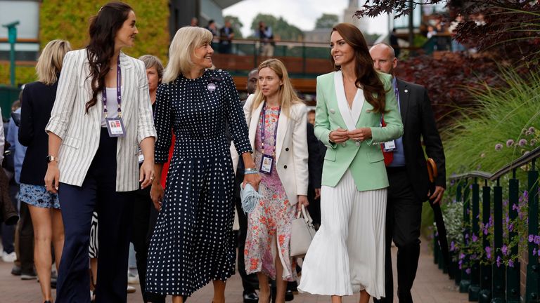 Catherine, Princess of Wales is accompanied by former players Laura Robson and Debbie Jevans as they walk through the grounds of Wimbledon 