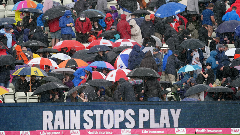 Fans shelter as rain stops play during the Vitality Blast T20 semi-final match at Edgbaston, Birmingham. Picture date: Saturday July 15, 2023.