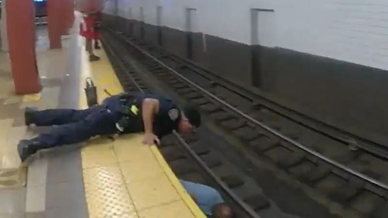 Bodycam footage shows NYPD officers jumping onto the train tracks and lifting a man to safety.