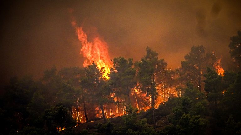 Smoke rises from a wildfire on the island of Rhodes, Greece, July 22, 2023. Argiris Mantikos/Eurokinissi via REUTERS ATTENTION EDITORS - THIS IMAGE HAS BEEN SUPPLIED BY A THIRD PARTY. NO RESALES. NO ARCHIVES. NO EDITORIAL SALES IN GREECE