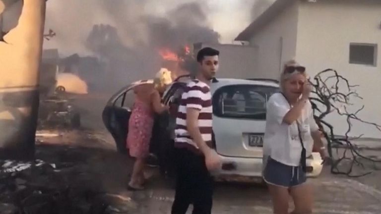 Locals in Rhodes see their homes destroyed by wildfires.