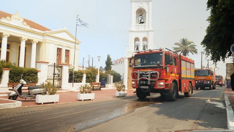 Firefighters arrive in the Greek village of Massari, on the east coast of Rhodes, as wildfires sweep in.