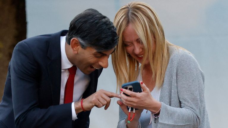 Rishi Sunak and Italy&#39;s Prime Minister Giorgia Meloni react ahead of the social dinner during the NATO summit