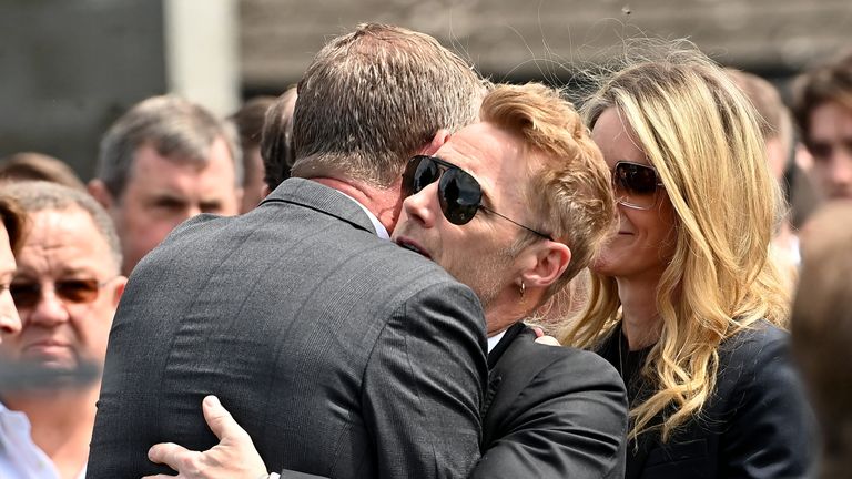 Ronan Keating and wife Storm (right) outside the cchurch after the funeral of his brother Ciaran Keating