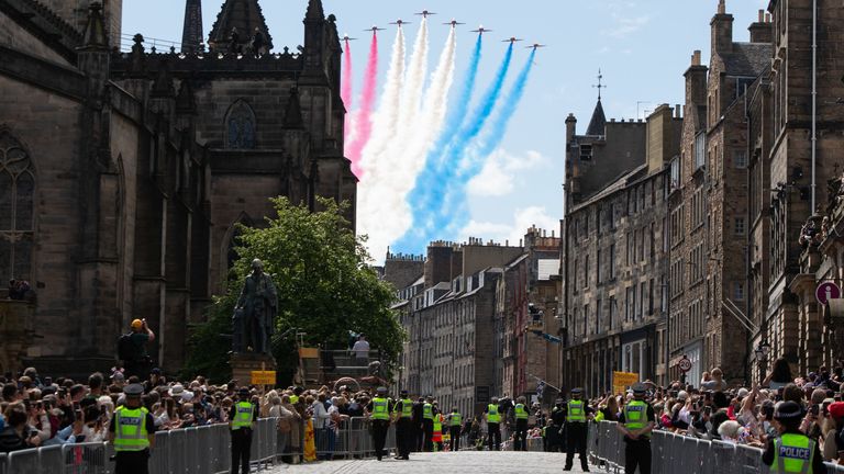 People watch a Red Arrows flypast after the National Service of Thanksgiving and Dedication for King Charles III and Queen Camilla, and the presentation of the Honours of Scotland, at St Giles&#39; Cathedral, Edinburgh. Picture date: Wednesday July 5, 2023.