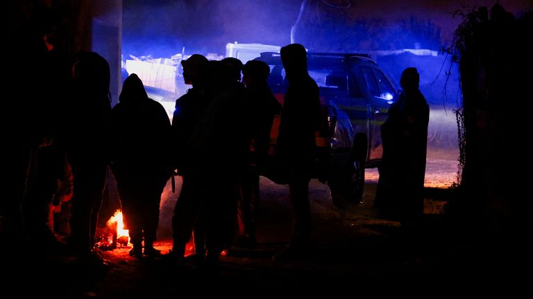 Onlookers gather at the scene following a suspected gas leak thought to be linked to illegal mining, in the Angelo shack settlement, near Boksburg, east of Johannesburg, South Africa July 6, 2023. REUTERS/Siphiwe Sibeko
